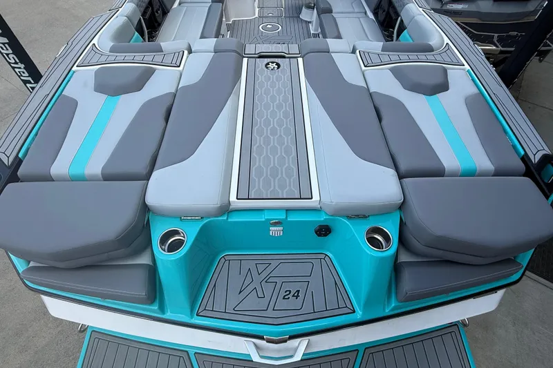 Slide: The Image of 2025 MasterCraft XT24 boat interior with gray and teal seating, showcasing modern design. - 19