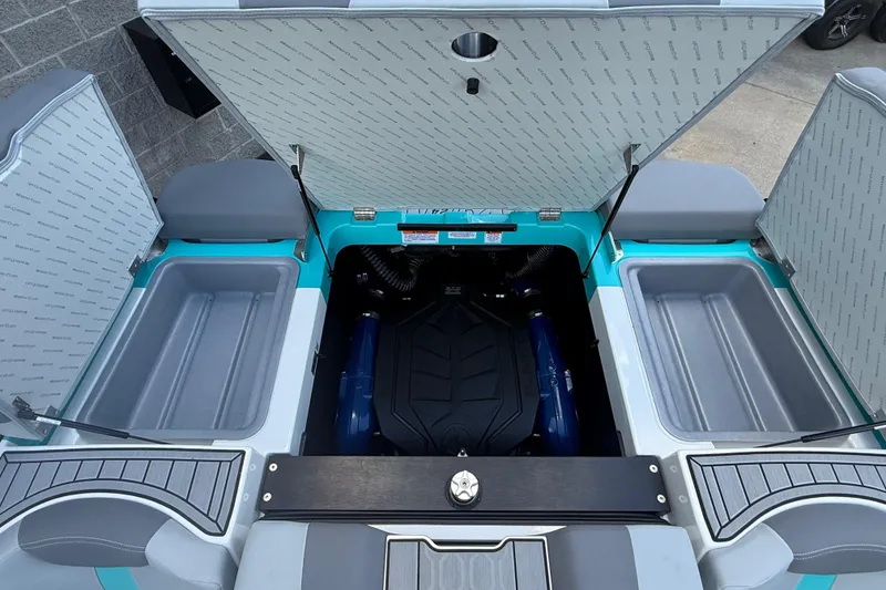 Slide: The Image of Open engine compartment of 2025 MasterCraft XT24 boat, showcasing storage and engine layout. - 21