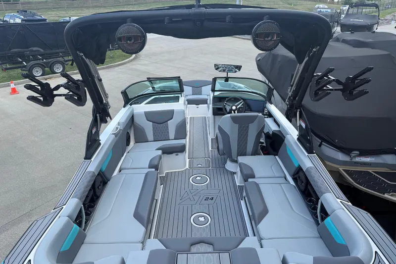Slide: The Image of 2025 MasterCraft XT24 boat interior with modern seating and advanced audio system. - 25
