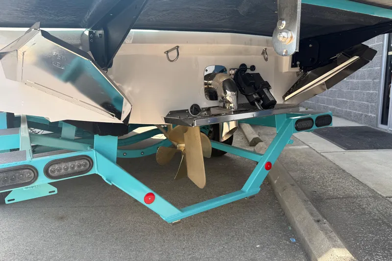 Slide: The Image of 2025 MasterCraft XT24 boat stern with propeller and trailer detail. - 26
