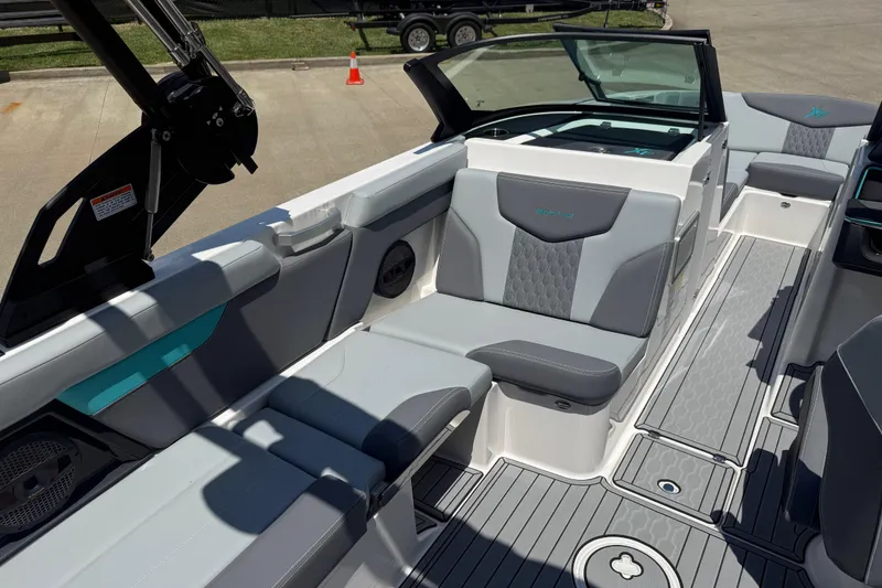 Slide: The Image of 2025 MasterCraft XT24 boat interior with gray seating and modern design. - 6