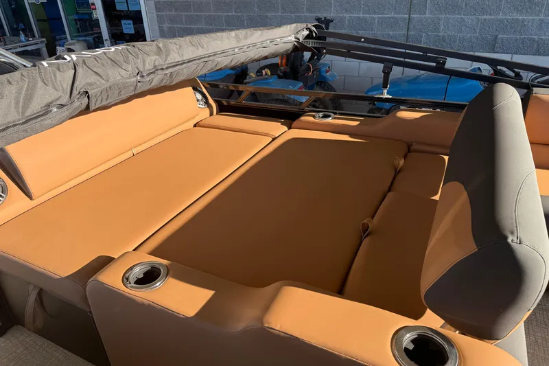 Slide: The Image of 2026 Avalon 2385 LSZ VRL boat interior with tan seating and cup holders. - 9