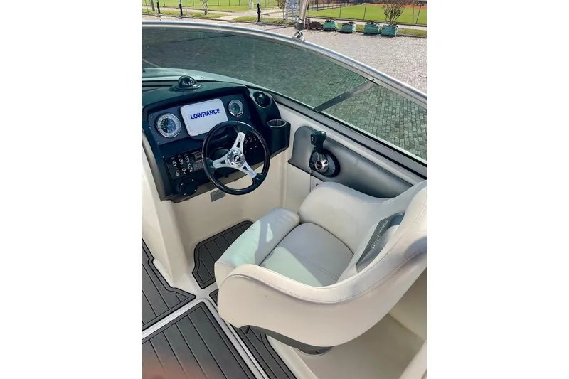 Slide: The Image of Cockpit of 2010 Sea Ray 300 Sundeck with steering wheel and navigation system. - 10
