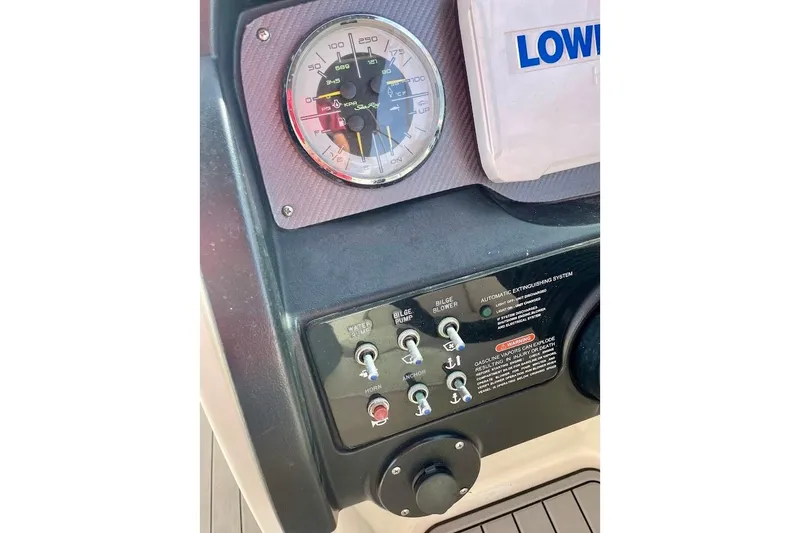 Slide: The Image of Control panel of a 2010 Sea Ray 300 Sundeck boat with gauges and switches. - 12