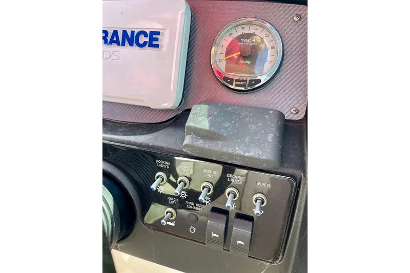 Slide: The Image of Control panel of a 2010 Sea Ray 300 Sundeck boat with switches and tachometer. - 13