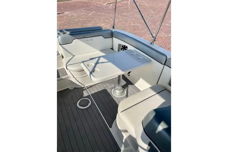 Slide: The Image of Interior of 2010 Sea Ray 300 Sundeck with seating and table setup. - 14