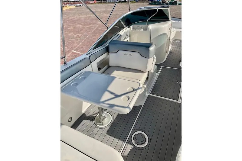 Slide: The Image of 2010 Sea Ray 300 Sundeck interior with seating and table on deck. - 16