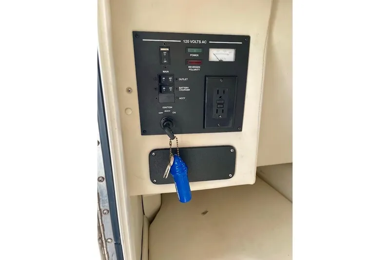 Slide: The Image of Control panel of a 2010 Sea Ray 300 Sundeck boat with ignition key. - 23
