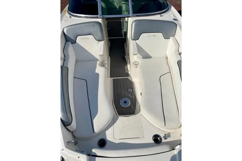 Slide: The Image of 2010 Sea Ray 300 Sundeck boat interior with white seating and wood flooring. - 7