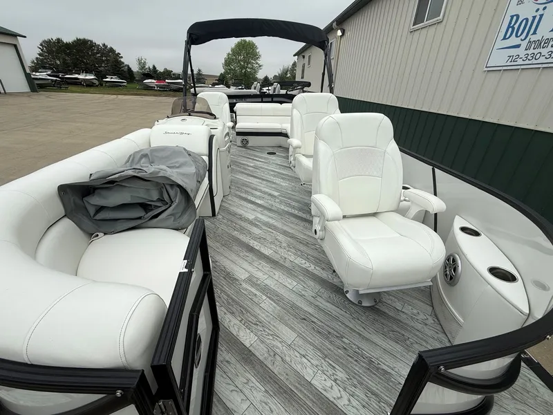 Slide: The Image of 2017 South Bay 500 Series boat with white seating and wood flooring. - 7