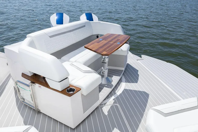 Slide: The Image of Manufacturer Provided Image: 2025 Tiara Yachts 43 LE luxury seating area with wooden table on deck. - 10