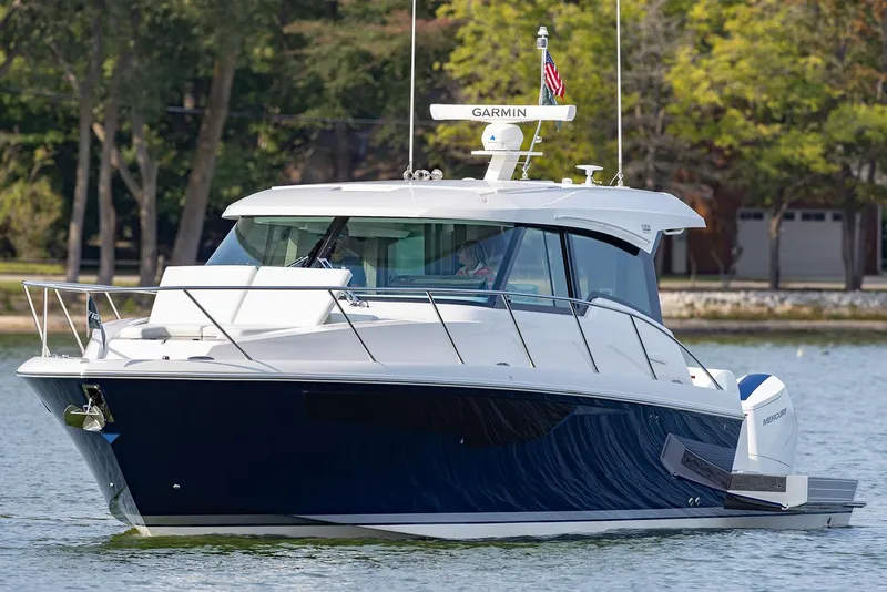 Slide: The Image of Manufacturer Provided Image: 2025 Tiara Yachts 43 LE luxury boat on calm water, featuring sleek design and modern technology. - 2
