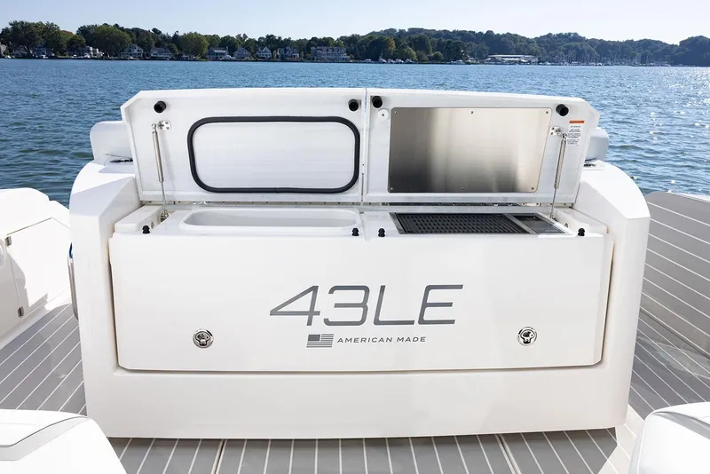 Slide: The Image of Manufacturer Provided Image: 2025 Tiara Yachts 43 LE boat deck with storage compartments, on a serene lake. - 9