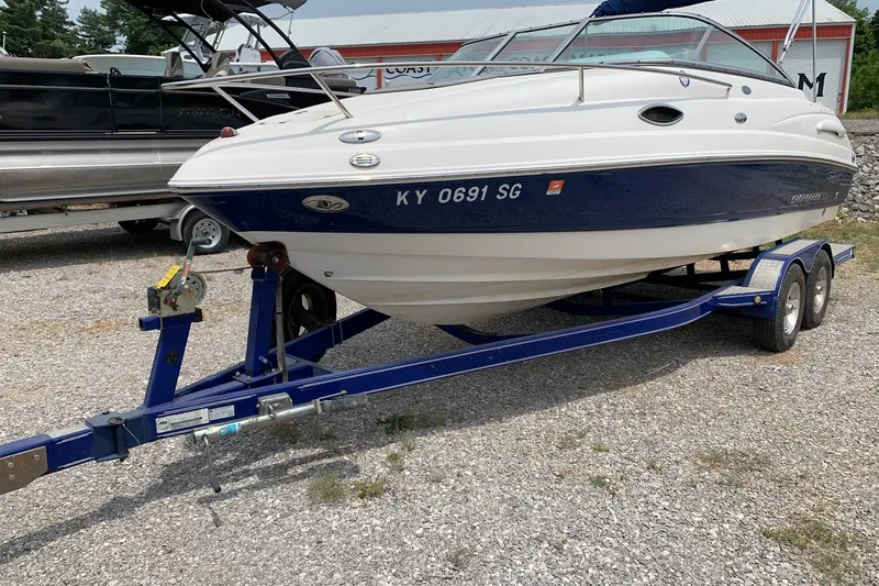 The Image of 2007 Chaparral 215 SSi boat on trailer, parked on gravel lot. - 0