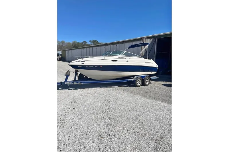Slide: The Image of 2007 Chaparral 215 SSi boat on trailer, parked outdoors near a building. - 2