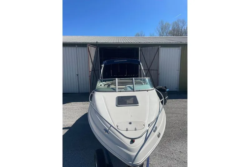Slide: The Image of 2007 Chaparral 215 SSi boat parked outside a storage shed under clear blue sky. - 4