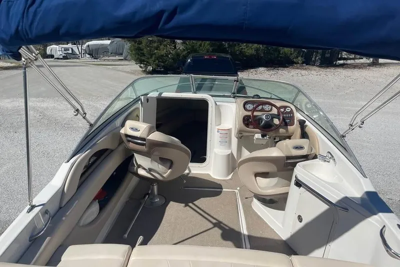 Slide: The Image of 2007 Chaparral 215 SSi boat interior with seating and steering wheel under blue canopy. - 5