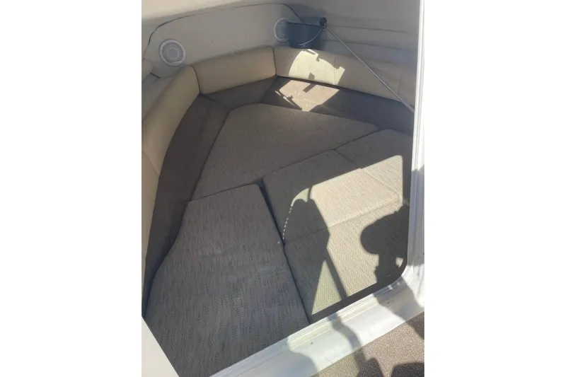 Slide: The Image of 2007 Chaparral 215 SSi boat interior cabin with cushioned seating and speakers. - 8