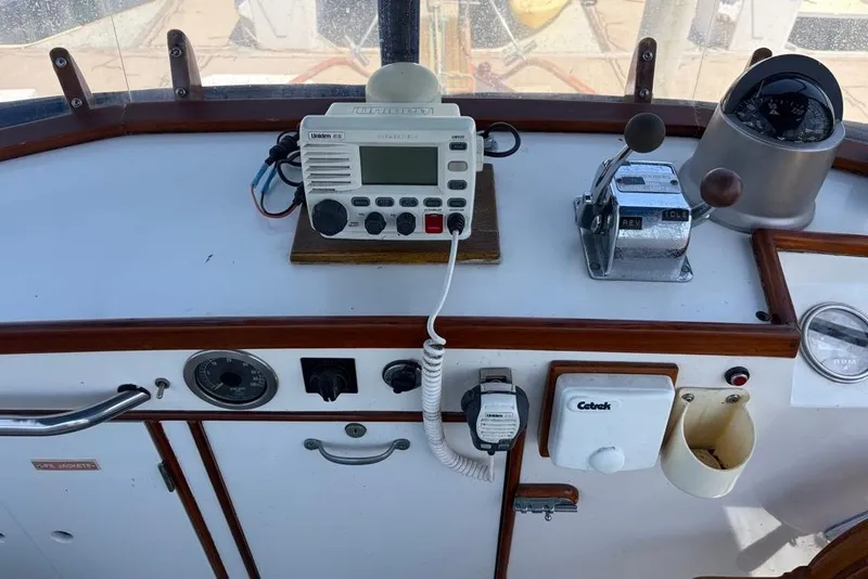 Slide: The Image of Control panel of a 1976 Grand Banks 32 Sedan boat with radio and navigation instruments. - 10