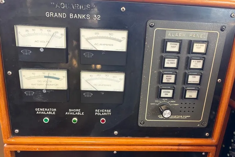 Slide: The Image of Control panel of a 1976 Grand Banks 32 Sedan boat with gauges and alarm indicators. - 13