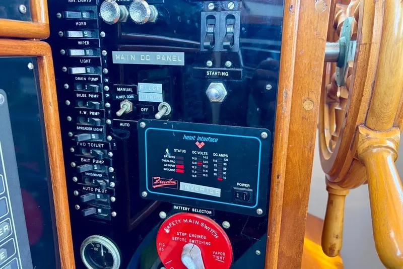 Slide: The Image of Control panel of a 1976 Grand Banks 32 Sedan boat with wooden steering wheel. - 15