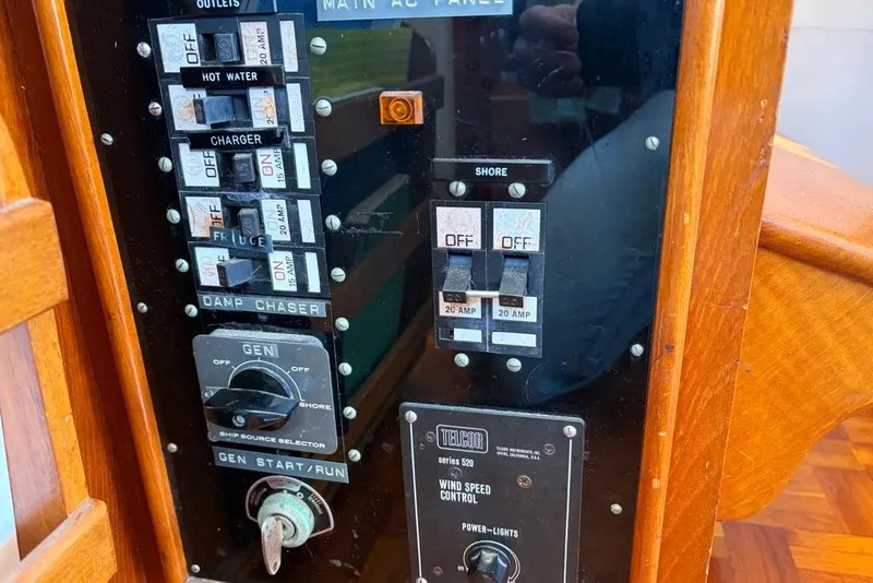 Slide: The Image of Electrical panel of a 1976 Grand Banks 32 Sedan boat, featuring switches and controls. - 16