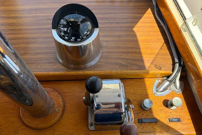 Slide: The Image of 1976 Grand Banks 32 Sedan helm with compass and throttle controls. - 18