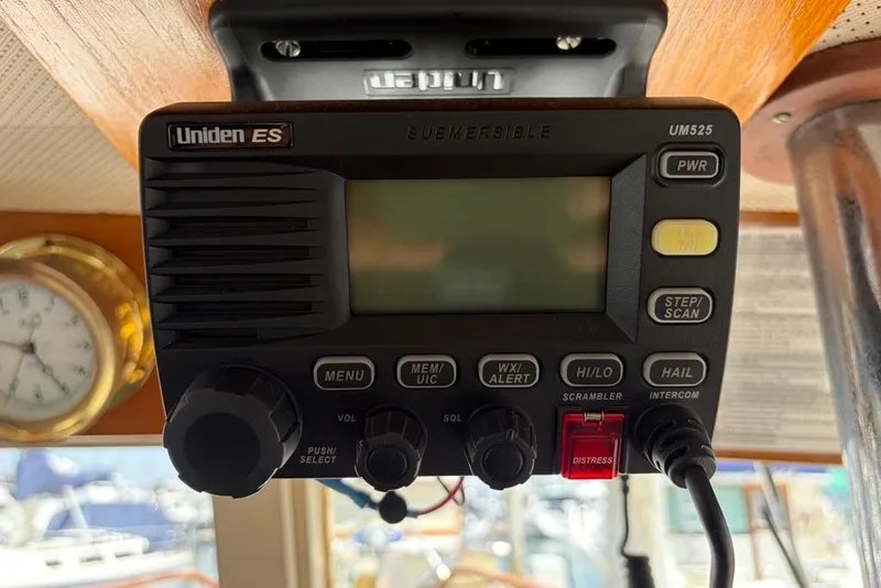 Slide: The Image of Uniden ES radio on 1976 Grand Banks 32 Sedan, featuring distress and communication controls. - 21
