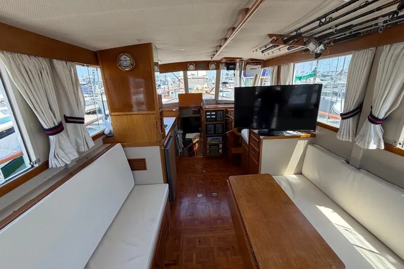 Slide: The Image of Interior of a 1976 Grand Banks 32 Sedan with seating, TV, and nautical decor. - 25