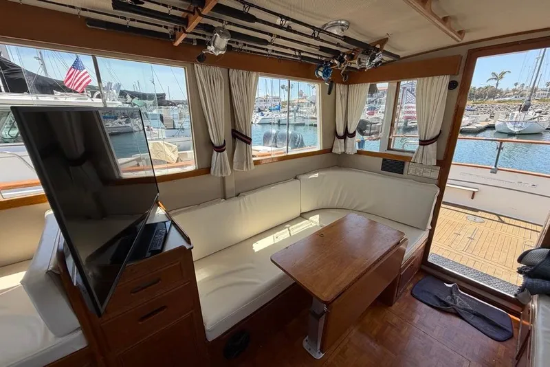 Slide: The Image of Interior of a 1976 Grand Banks 32 Sedan with cozy seating and a waterfront view. - 26