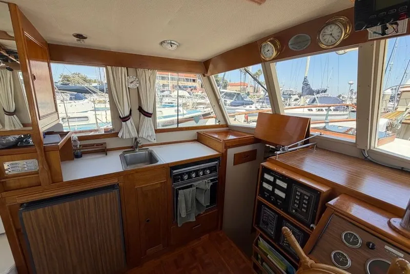 Slide: The Image of Interior of a 1976 Grand Banks 32 Sedan yacht with kitchen and control panel. - 27