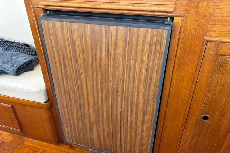 Slide: The Image of Wood-paneled refrigerator in 1976 Grand Banks 32 Sedan boat interior. - 31