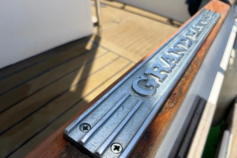Slide: The Image of 1976 Grand Banks 32 Sedan boat deck with engraved metal nameplate. - 32