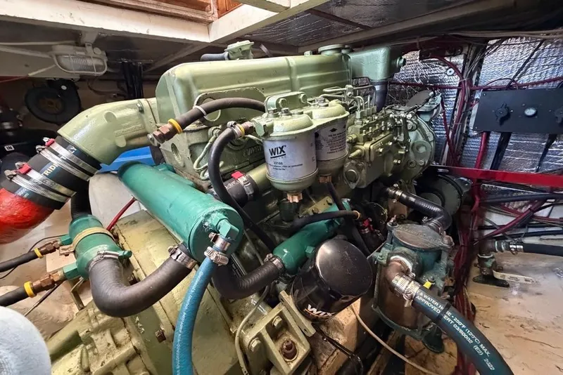 Slide: The Image of Engine room of a 1976 Grand Banks 32 Sedan, showcasing detailed mechanical components. - 33