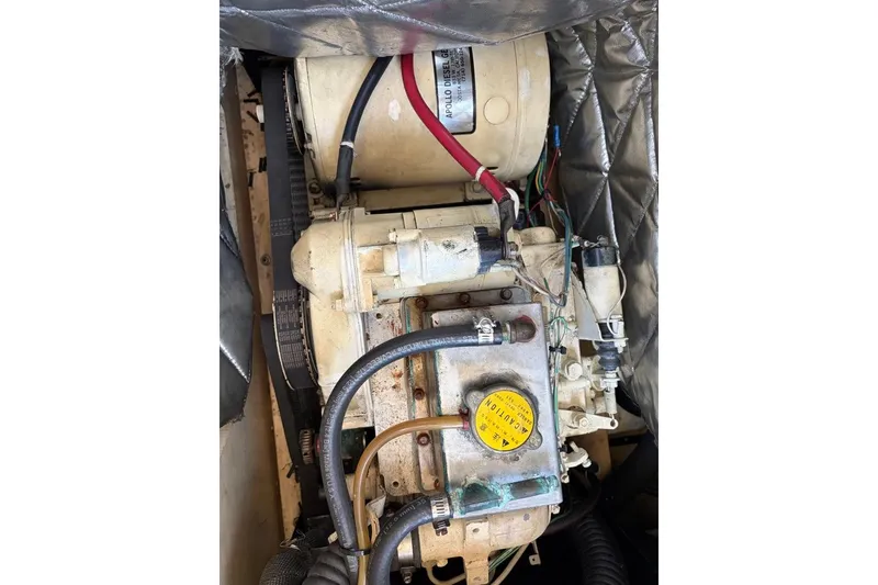Slide: The Image of Engine compartment of a 1976 Grand Banks 32 Sedan boat, featuring Apollo Diesel components. - 34