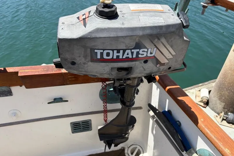 Slide: The Image of Tohatsu outboard motor on 1976 Grand Banks 32 Sedan boat, docked by the water. - 7