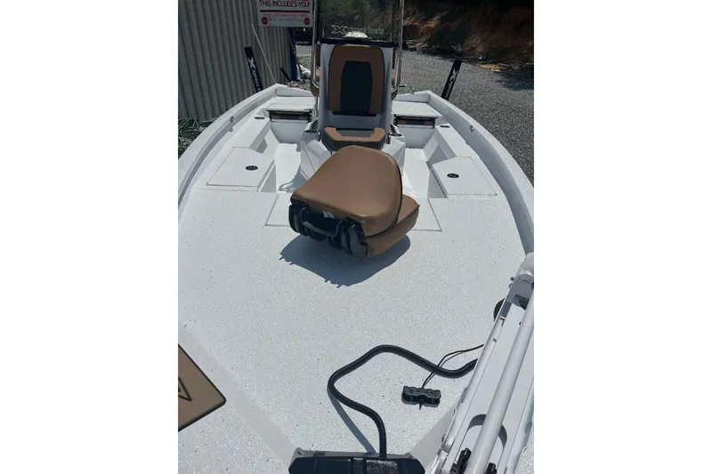 Slide: The Image of 2026 Xpress H20B Bay boat interior with tan seating and white deck. - 7