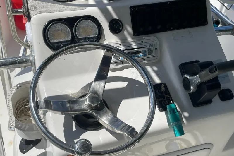 Slide: The Image of Steering console of a 2004 Century 1901 Bay Boat with controls and gauges. - 11