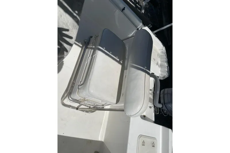 Slide: The Image of 2004 Century 1901 Bay Boat seating area with white cushioned seats and metal frame. - 12