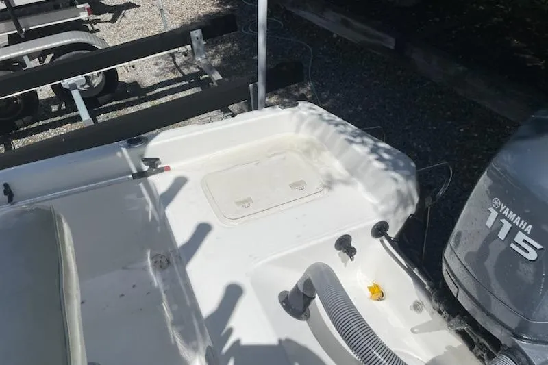 Slide: The Image of 2004 Century 1901 Bay Boat with Yamaha 115 engine, docked on a trailer. - 15