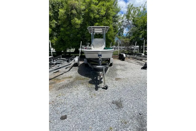 Slide: The Image of 2004 Century 1901 Bay Boat on trailer, parked outdoors with trees in background. - 17