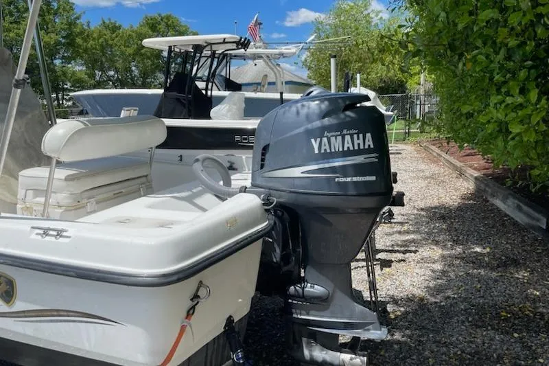 Slide: The Image of 2004 Century 1901 Bay Boat with Yamaha engine, parked outdoors. - 18