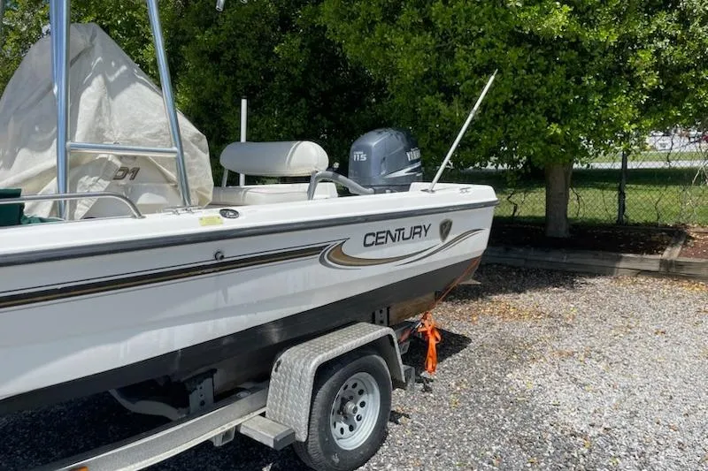 Slide: The Image of 2004 Century 1901 Bay Boat on trailer, parked outdoors near trees. - 3