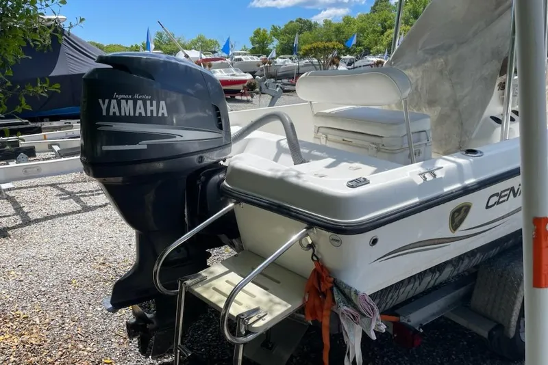 Slide: The Image of 2004 Century 1901 Bay Boat with Yamaha outboard motor in a marina setting. - 4
