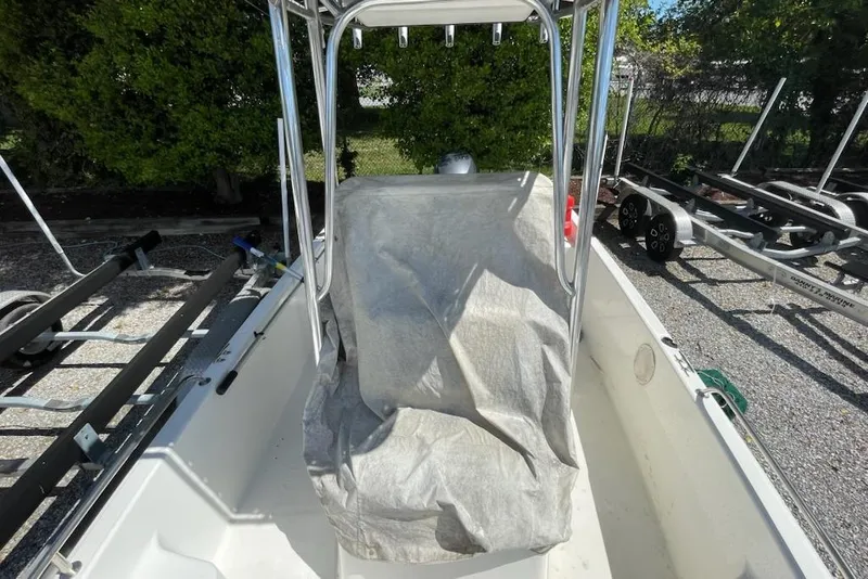 Slide: The Image of 2004 Century 1901 Bay Boat interior with covered console, parked on a trailer. - 5