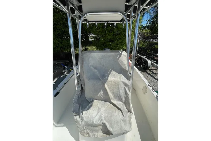 Slide: The Image of 2004 Century 1901 Bay Boat interior with covered console and metal frame. - 6