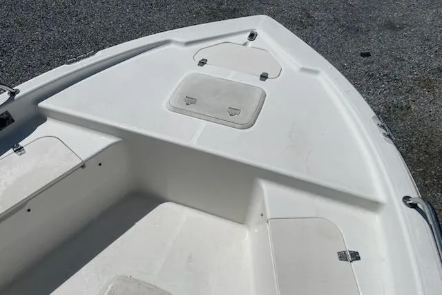 Slide: The Image of 2004 Century 1901 Bay Boat bow with storage compartments on gravel surface. - 7