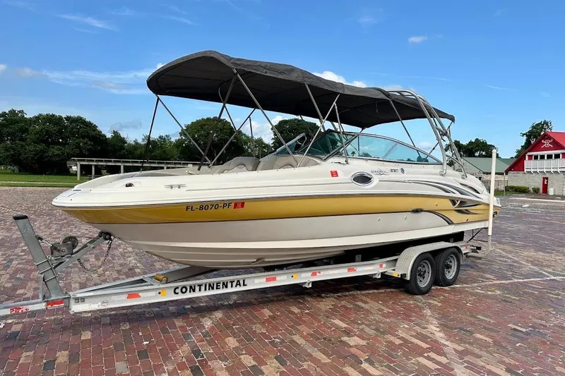 The Image of 2004 Sea Ray 270 Sundeck boat on trailer, parked on brick pavement. - 1