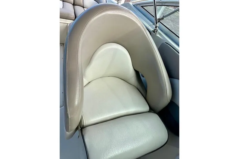 Slide: The Image of 2004 Sea Ray 270 Sundeck boat seat, featuring beige leather upholstery. - 22