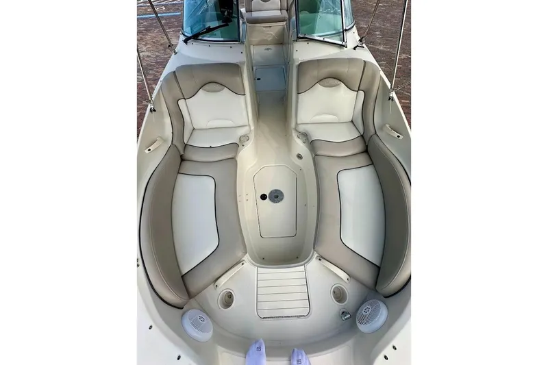 Slide: The Image of 2004 Sea Ray 270 Sundeck boat interior with beige seating and spacious layout. - 38